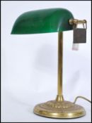 A vintage 20th century gilt brass bankers lamp raised on circular base with adjustable green glass