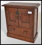 A Victorian carved oak smokers table top cabinet b