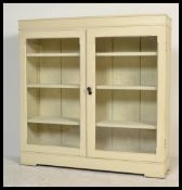 A late 19th century glazed library bookcase display cabinet. Twin glazed doors with fitted wooden