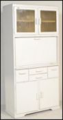 A retro mid century, circa 1950's kitchen dresser having mottled glass cupboard over fall front