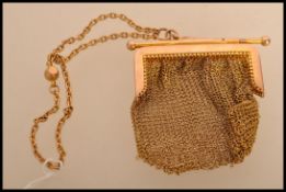 A 9ct gold ladies mesh purse having a yellow metal test as 9ct gold chain. Gross weight 38.8.