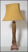 A vintage medieval style carved wooden table lamp of tall form depicting a king raised on plinth