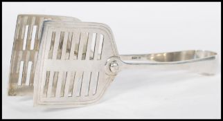 A large pair of early 20th century Edwardian serving tongs having a shaped open cut end with non
