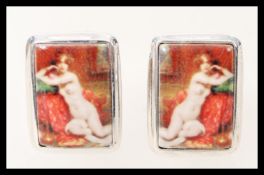 A pair of mens silver cufflinks having square enamelled panels depicting pictures of a nude female