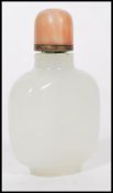 A 19th century Chinese white / light green jade snuff bottle with red coral top complete with