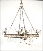 A 20th century cut glass ceiling chandelier of square form with clear faceted drops and scrolled