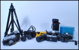 A collection of vintage 20th Century 35mm cameras and lenses, to include Tamashi, Asahi Pentax,