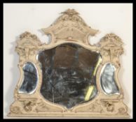 A large 19th Century wall / overmantel mirror with three shaped mirror panels, and a craved wood and