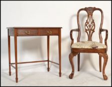 An Edwardian mahogany writing table desk having square tapering legs united by stretchers. Above