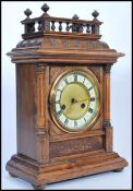 An early 20th Century H A C mahogany bracket clock of architectural form, enamel and gilt face