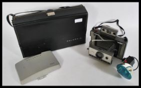 A Polaroid land 320 camera in a Polaroid leatheret