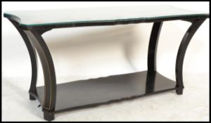 A 20th Century Heal's manner black lacquered coffee table having a gilt chinoserie Japanese scene