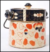 A 19th Century ceramic English Imari biscuit barrel / jar, having a twisted metal handle and