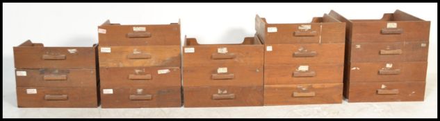 A group of approx eighteen oak early 20th ecntury shop haberdashery cabinet drawers of varying