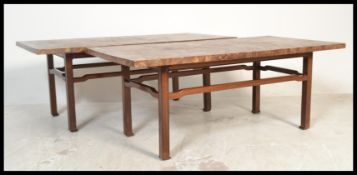 A pair of mid century large coffee - occasional tables each raised on teak wood supports having