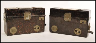 A pair of vintage bakelite cased ( possibly military ) field telephones, both fitted with hinged