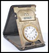 A fantastic vintage early 20th century travelling clock and desk calendar compendium featuring an