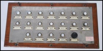 A vintage early 20th century oak cased schools butlers servant bell board having enamel and metal