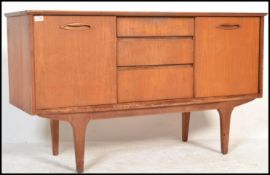 A retro 20th Century teak wood Danish inspired sideboard / Credenza, having a central bank of