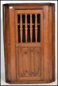 A 19th century Carved oak country hanging corner cabinet. Twin panel door being decoratively pierced