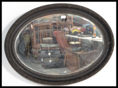 A 19th century oval bevelled glass mirror, in a pa