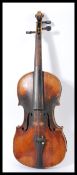 A late 19th century violin having a one piece maple back and spruce front. Shaped hollow body with