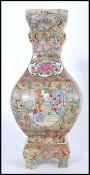A Chinese Qianlong mark vase on stand. The bulbous square vase having hand painted scenes of court