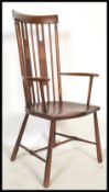 A Victorian Art Nouveau mahogany Goldsmiths Windsor chair / armchair being raised on turned legs