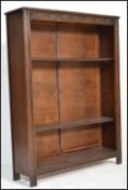 A Victorian antique style oak open window bookcase cabinet having carved details to the sides with
