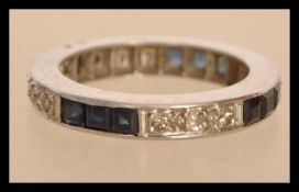 A white gold eternity ring set with square blue sapphires and round cut diamonds. Size K.5. Weight