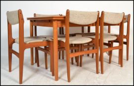 A 1970's Danish teak wood extending dining room suite comprising of a good draw leaf table being