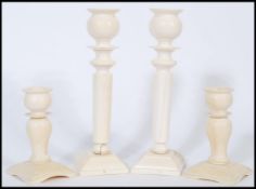 A collection of 4 19th century Ivory carved candlesticks to include a large pair with turned stems
