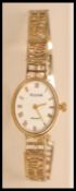 A ladies hallmarked 9ct Accurist cocktail watch having an oval face with roman numerals to the