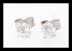 A pair of white gold earrings with prong set brilliant cut diamonds. Approx 85pts total. Weight 0.