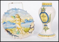 An early 19th century Italian Faience vase having armorial decoration along with a similar plate