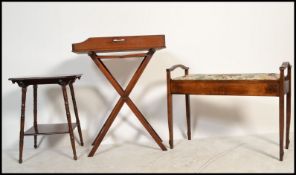 An Edwardian mahogany duet piano stool together with a butlers mahogany folding tray and an
