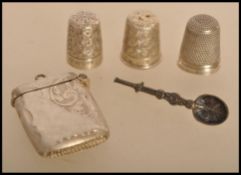 A selection of early 20th century silver items to include a small silver vesta pendant with scrolled