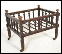 A 19th century Victorian mahogany spindle gallery cat bed having turned columns and railed tray