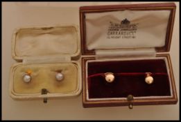 Twos pair of hallmarked 9ct gold collar studs complete in fitted cases one having pearl ends.