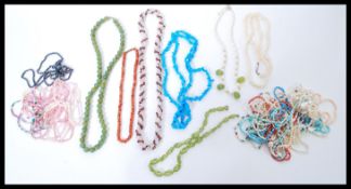A selection of vintage necklaces to include a jade coloured hard stone necklace, a beaded red