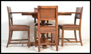 A 20th century oak circular dining table of pedestal form being raised on turned column with splayed