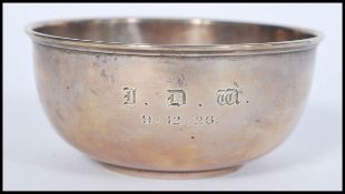 A hallmarked silver early 20th century bowl of simple form raised on a circular foot. Monogrammed