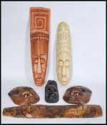 A selection of 20th century African tribal wall masks to include a pair of monkey face masks with