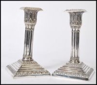 A pair of 19th Century William Hutton & Sons silver plated candlesticks, having graduating square