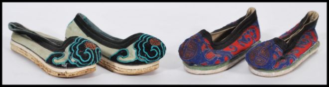 Two pairs of 19th century Chinese embroidered binding / bound shoes both with medallions to front