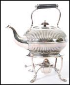 An early 20th Century silver plated spirit kettle on stand, having a turned dark wood handle and
