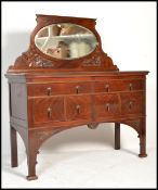 An Edwardian mahogany sideboard having squared legs with a series of drawers to the small
