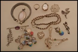 A selection of white metal and silver jewellery to include a souvenir bracelet with enamelled