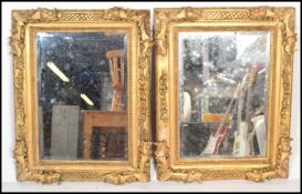 A pair of 20th century contemporary carved rectangular gilt wooden Florentine framed mirrors