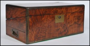 A 19th century Georgian walnut and brass bound writing slope box. Hinged centre with open interior (